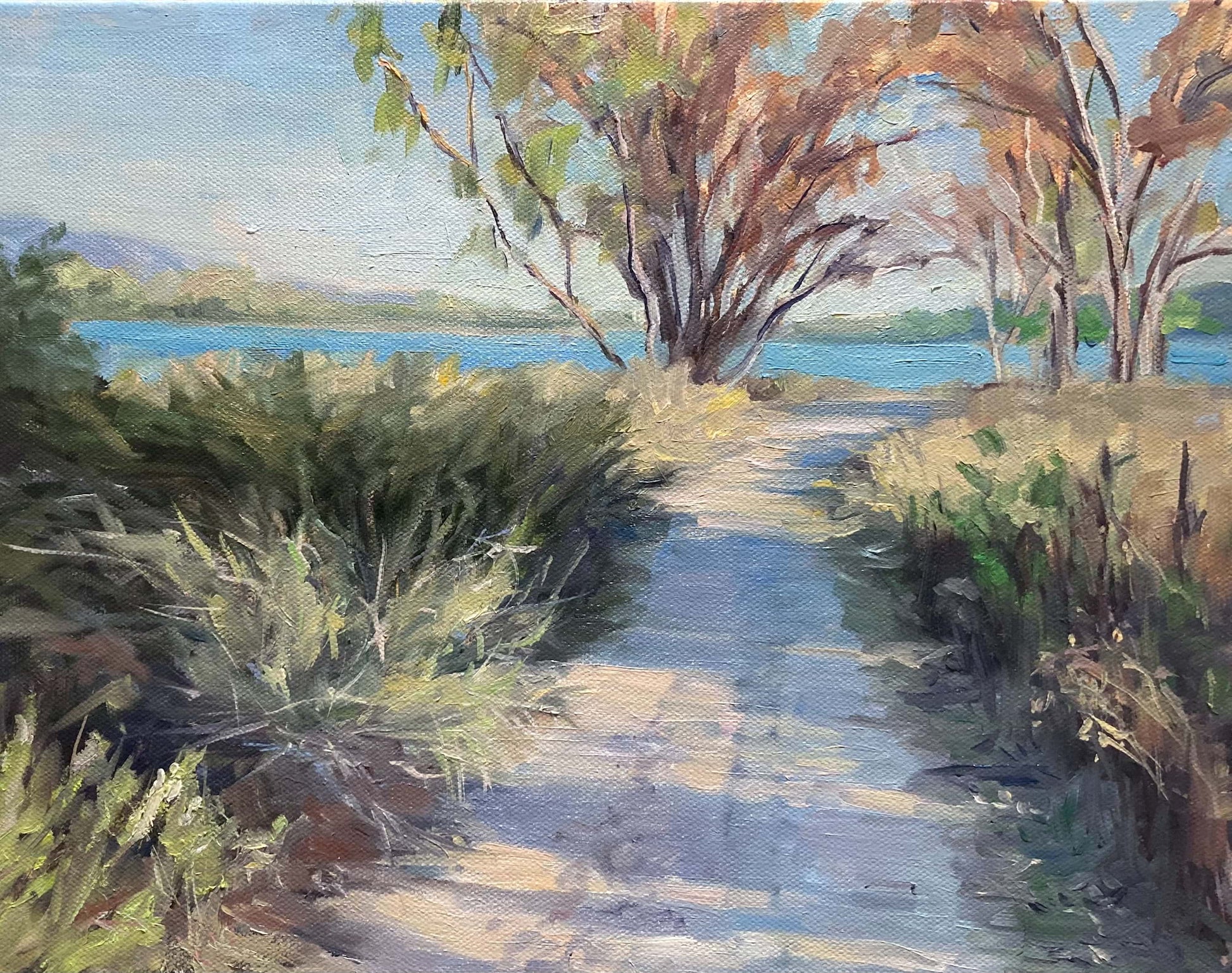 Painting of a path crossed by areas of shade, leading to trees and a lake.