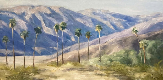 Palm trees in Anza Borrego Desert State Park, CA..  Be hing the lind of palms a mountain looms in the distance. 